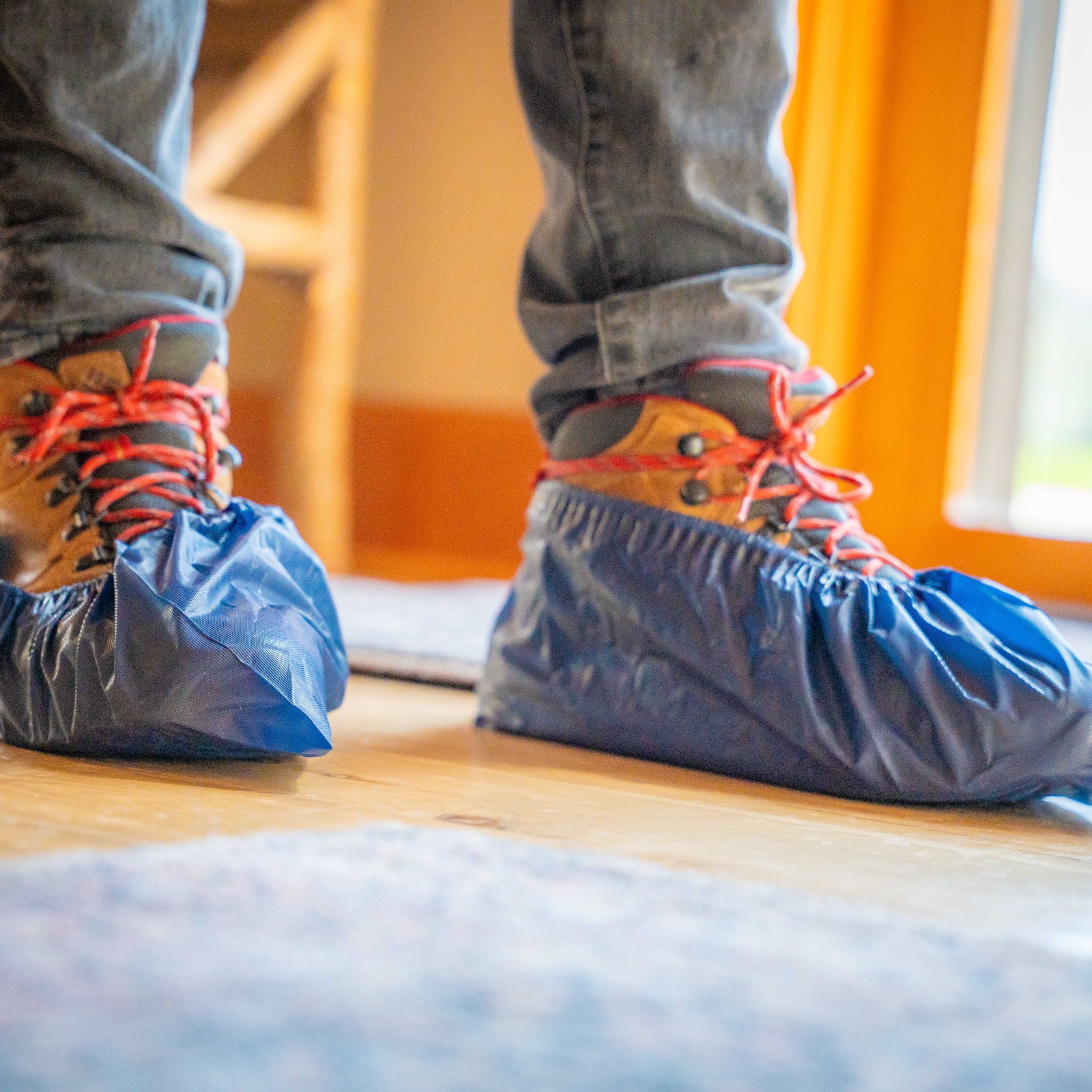 TOPRUNG technician wearing protective shoe covers inside a home
