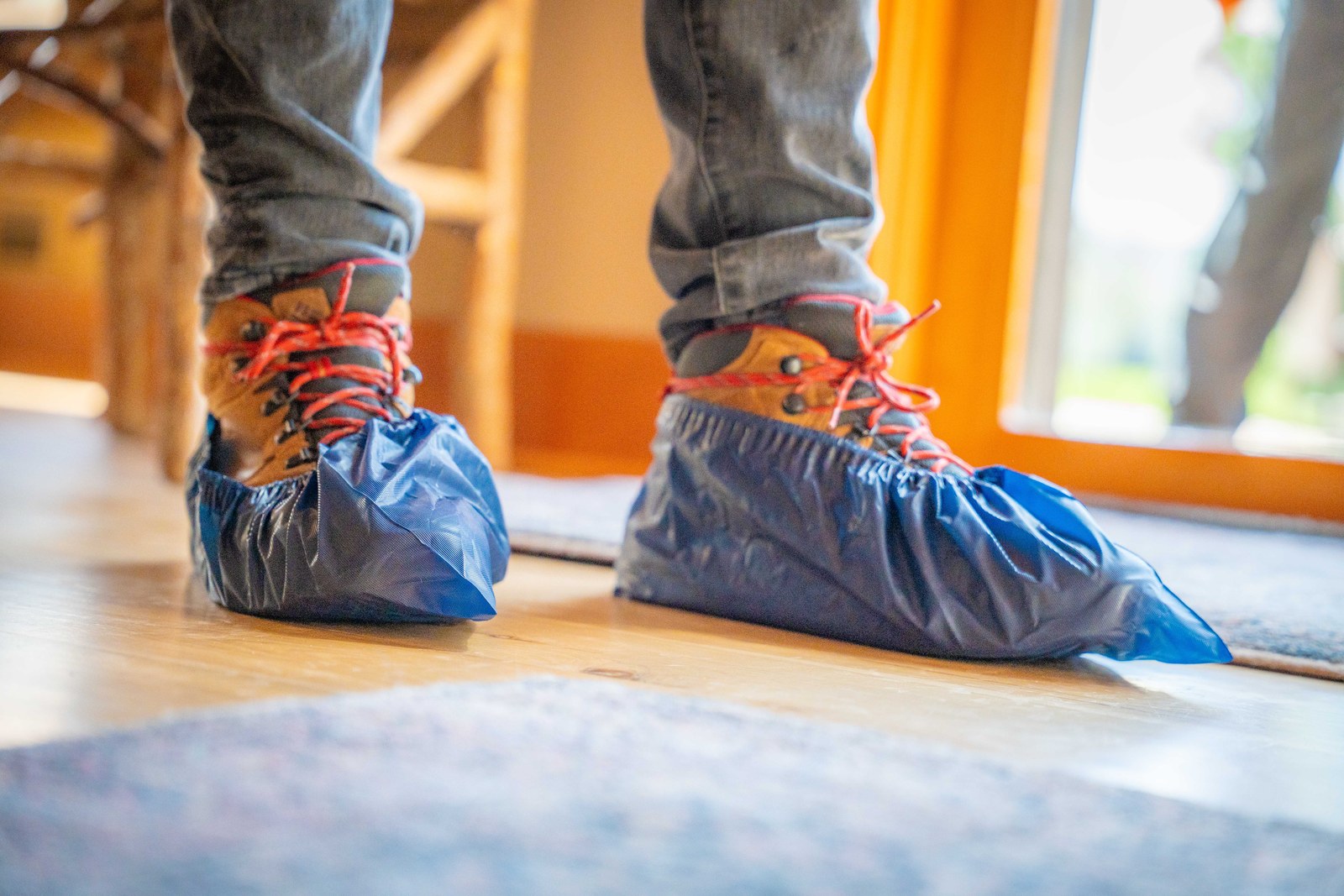 TOPRUNG technician wearing protective shoe covers while working inside a home
