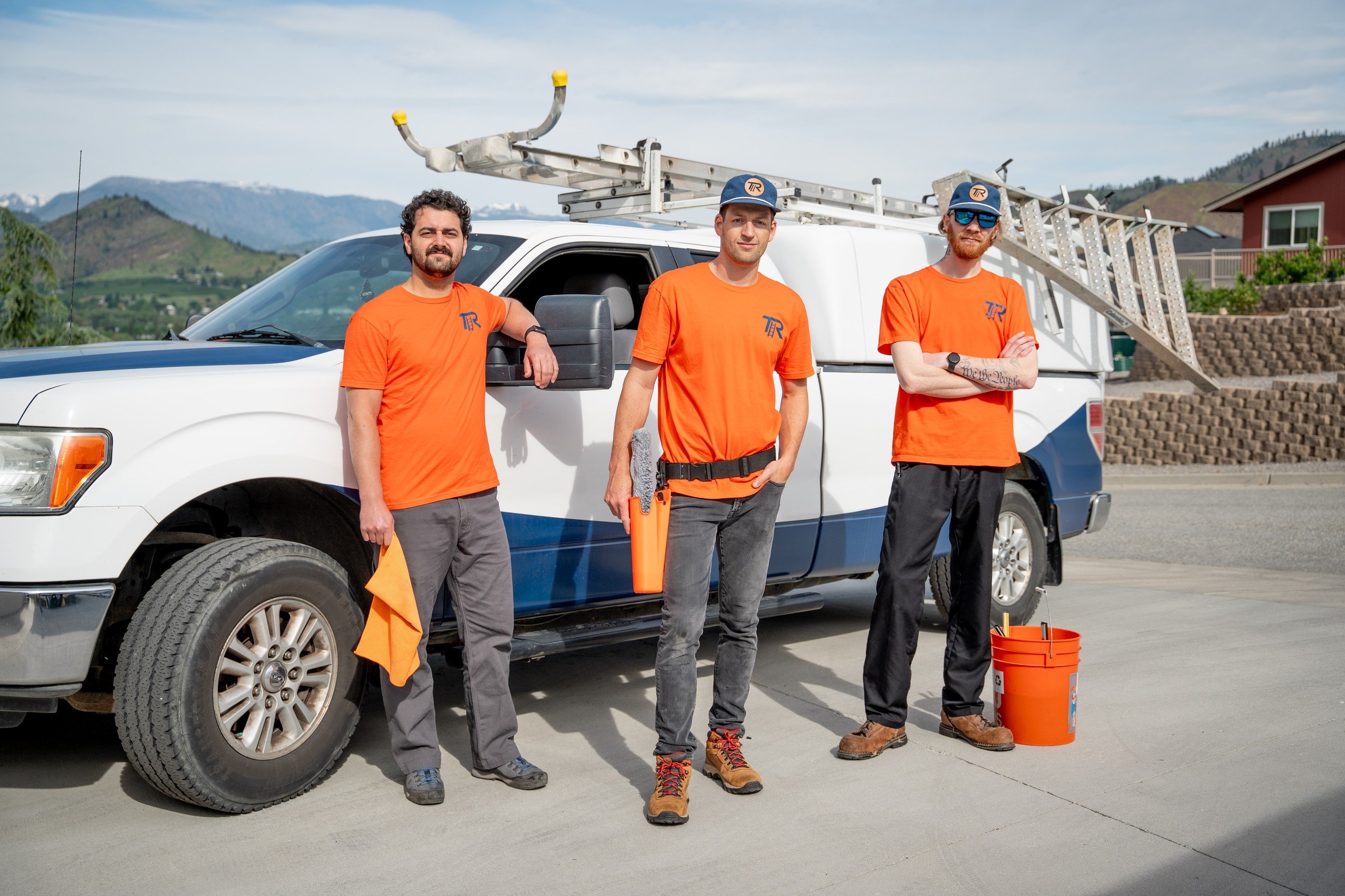 TOPRUNG window cleaning crew beside a branded service truck in Wenatchee