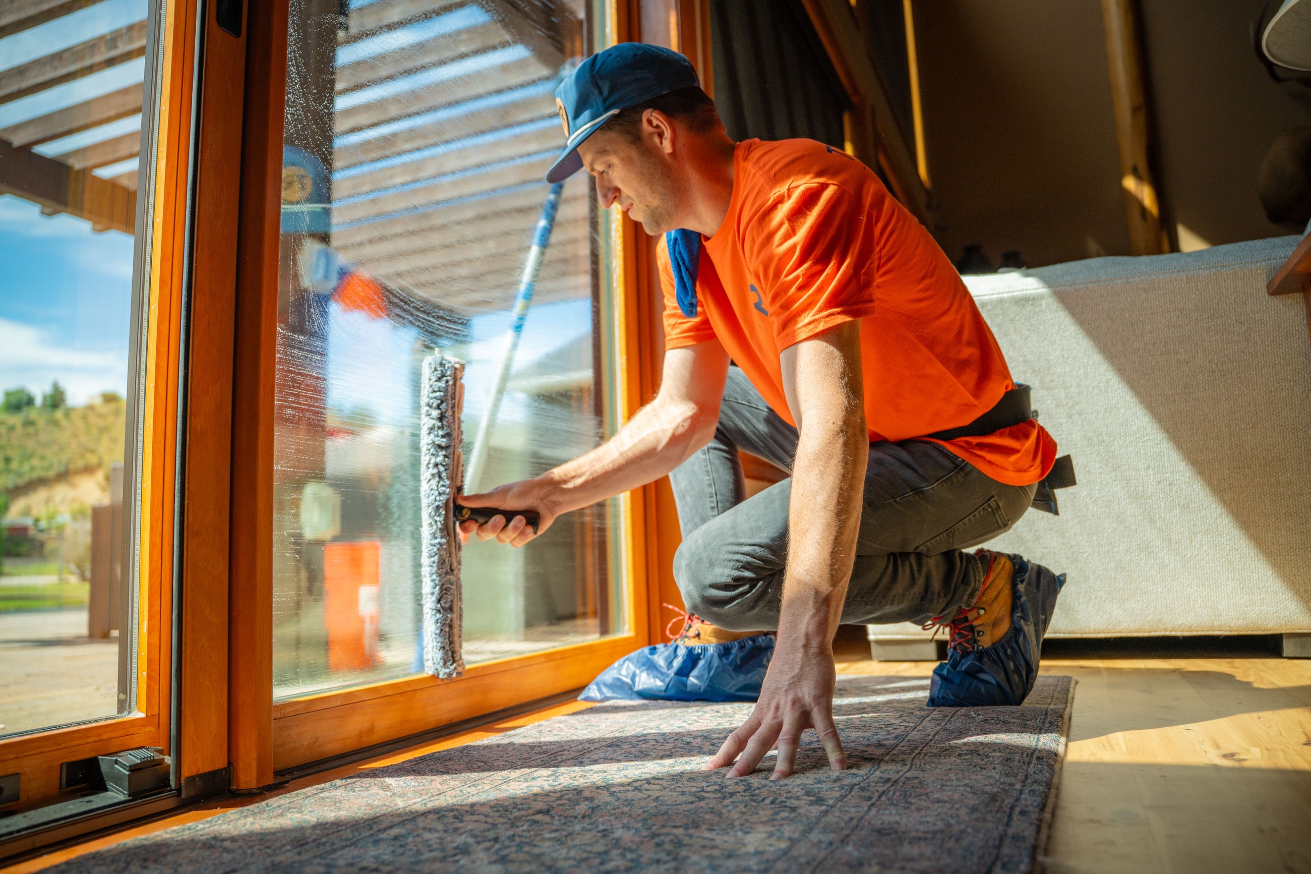 TOPRUNG technician detailing interior residential windows by hand