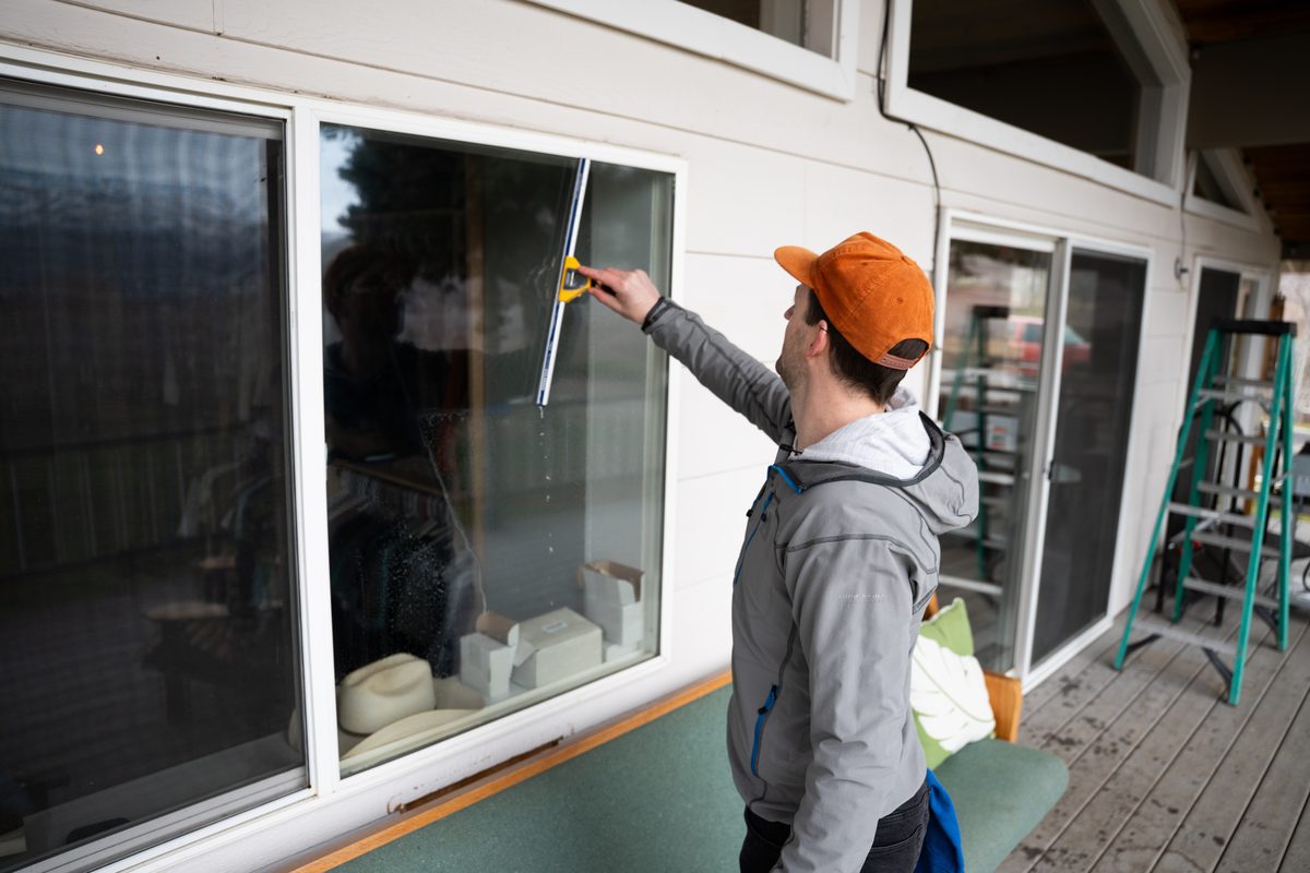Close-up of squeegee cleaning glass surface