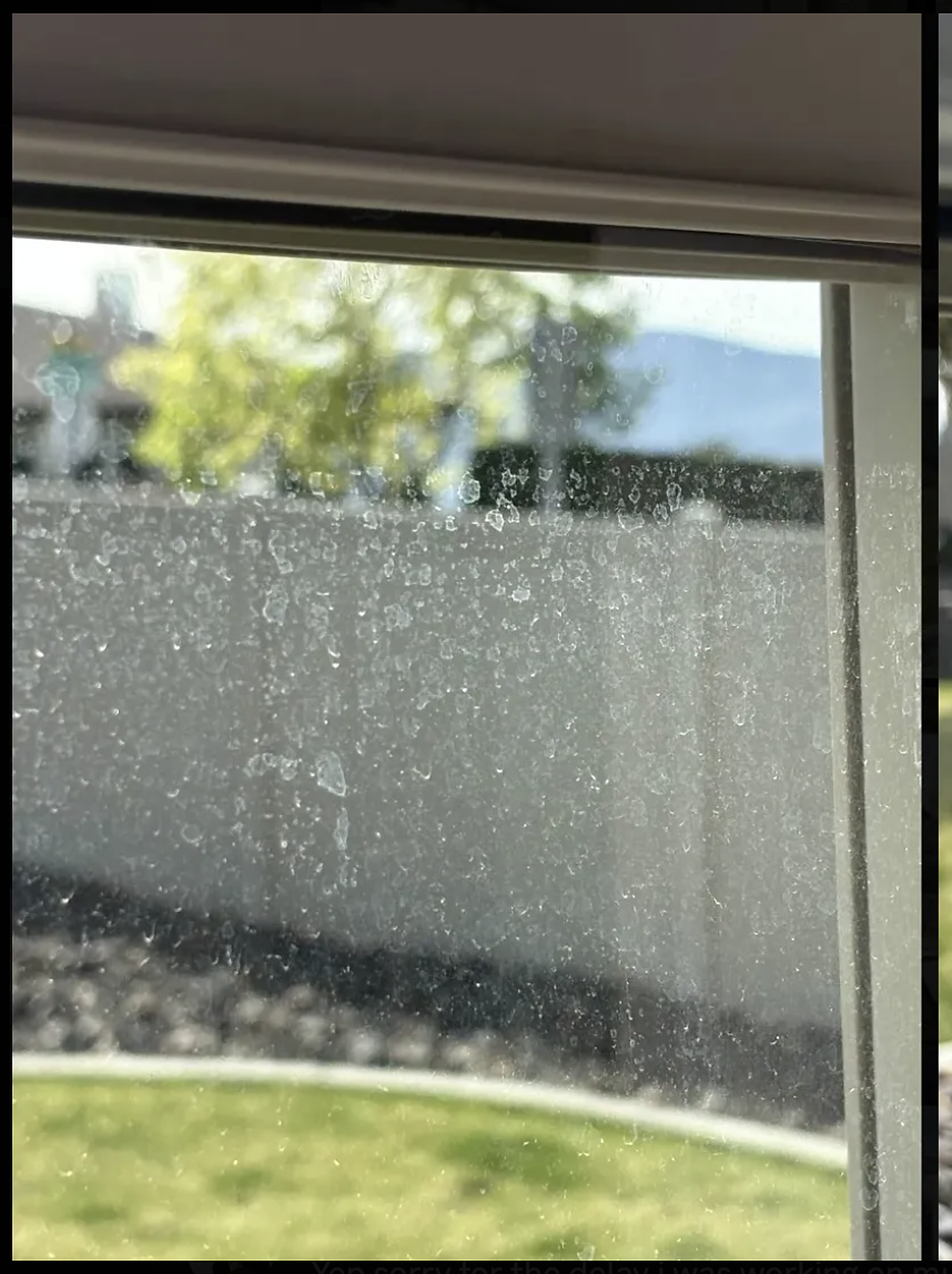 Window with hard water mineral staining before treatment